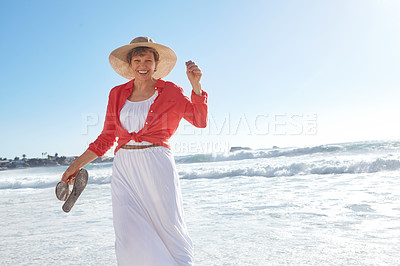 Buy stock photo Portrait of an attractive mature woman enjoying a day at the beach