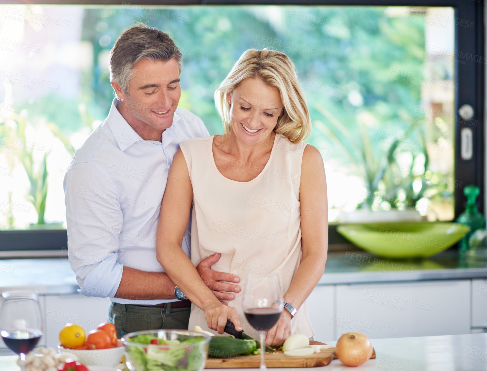 Buy stock photo Cropped shot of an affectionate couple cooking dinner
