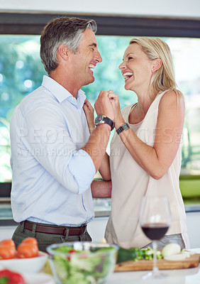 Buy stock photo Cropped shot of an affectionate couple cooking dinner 