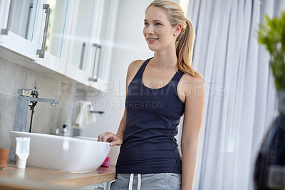 Buy stock photo Shot of an attractive young woman in her bathroom