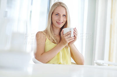 Buy stock photo Shot of an attractive young woman drinking a coffee at home