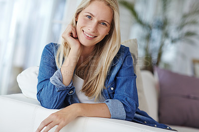 Buy stock photo Portrait of an attractive young woman relaxing on her sofa at home