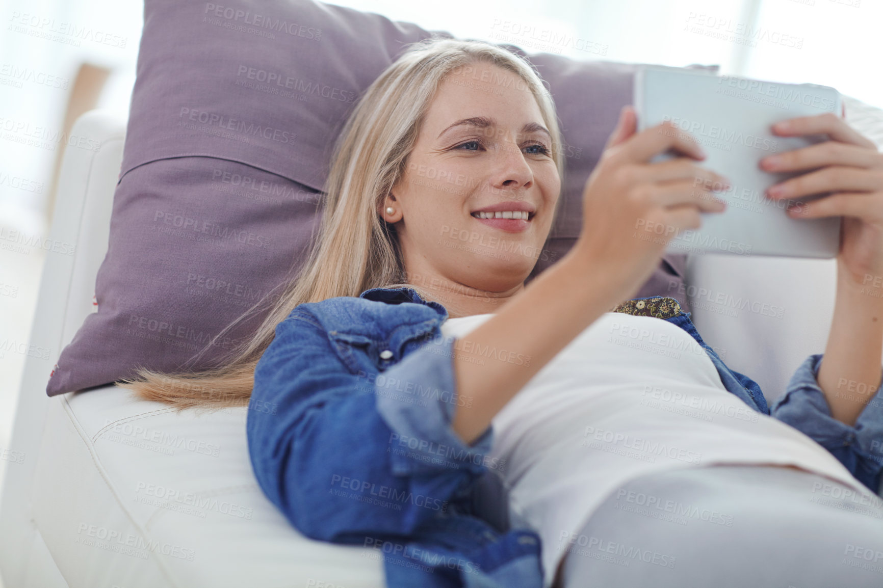 Buy stock photo Shot of an attractive young woman relaxing at home