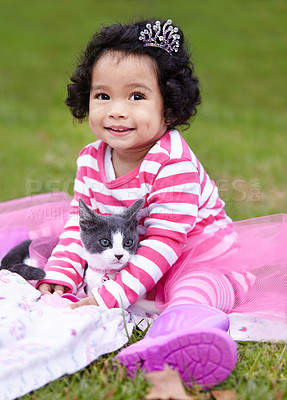 Buy stock photo Nature, crown and girl with kitten in a garden on grass on a summer weekend together. Happy, sunshine and portrait of child with tiara sitting and having fun with cat, animal or pet on lawn in field.