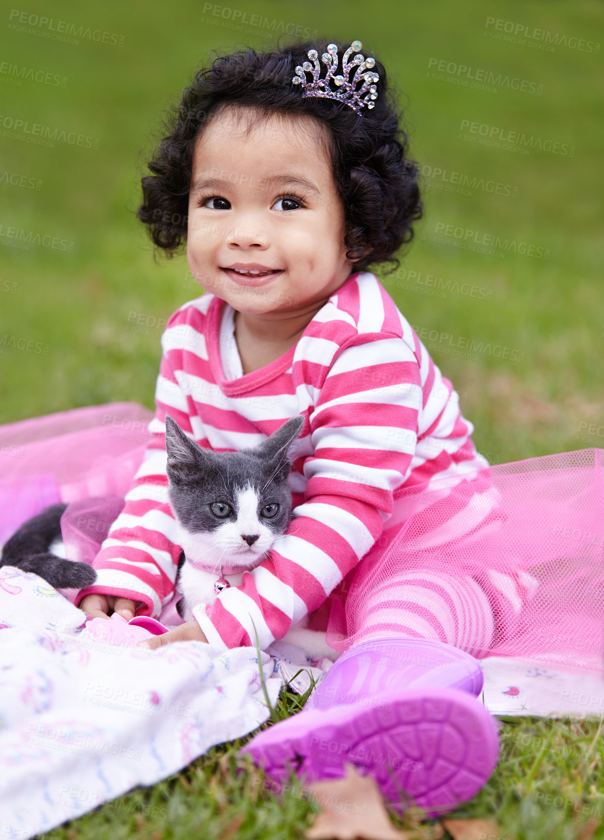 Buy stock photo Nature, crown and girl with kitten in a garden on grass on a summer weekend together. Happy, sunshine and portrait of child with tiara sitting and having fun with cat, animal or pet on lawn in field.