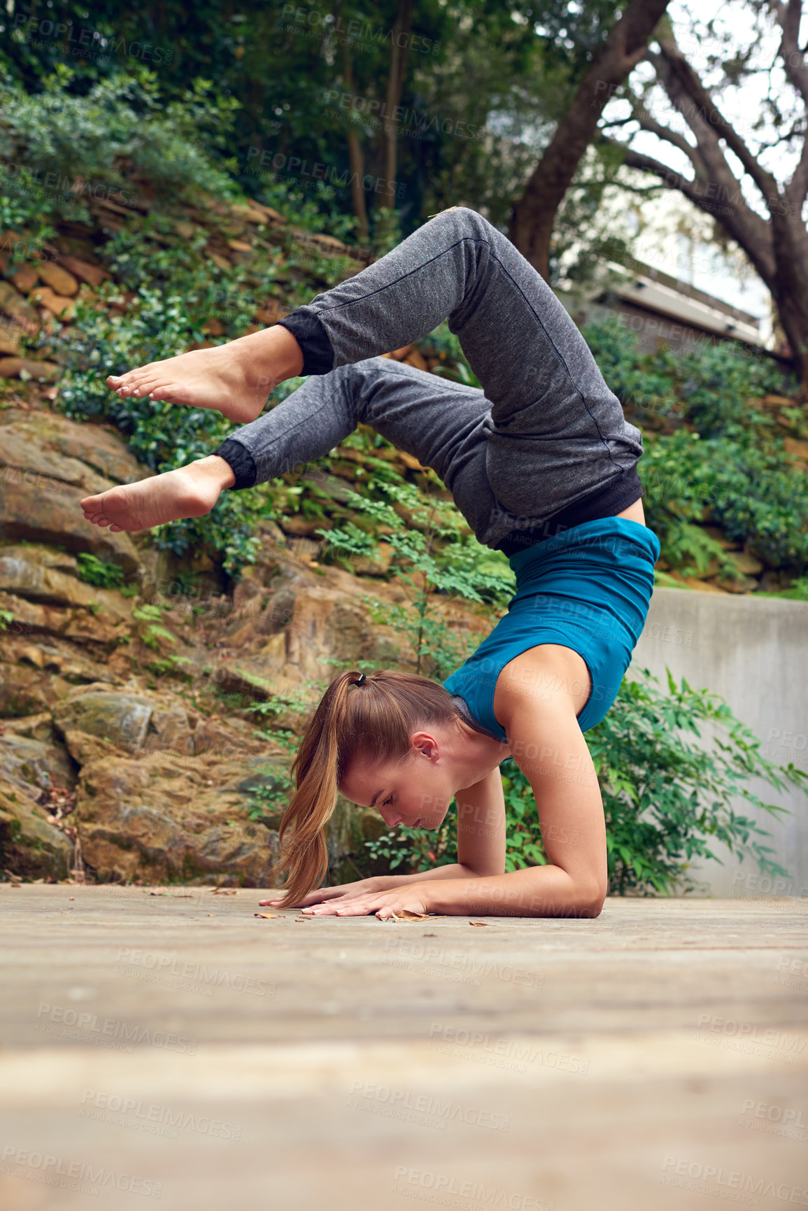 Buy stock photo Woman, yoga and patio with balance, handstand and challenge on garden deck outside home. Zen, heath and wellness with holistic practice, posture and wood floor with body health for flexibility