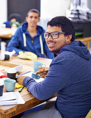 Buy stock photo Businessman, portrait and lunch by desk in office with happiness for eating break, pizza and coworking company. Programmer, employee and face with glasses, fast food and coding team at workspace 
