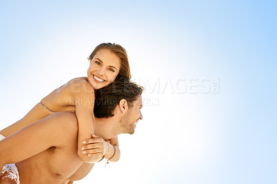 Buy stock photo Beach, mockup and couple piggyback with love, care and support, trust and bonding on blue sky background. Space, face and happy people hug at sea for travel, adventure and summer, vacation or holiday