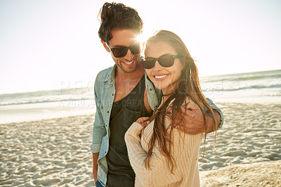 Buy stock photo Couple, sea and sunglasses with hug, happy or care for fashion, eye protection or vacation in summer. Man, woman and embrace in glasses at beach for sun, smile and love by ocean on tropical holiday