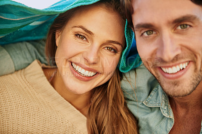 Buy stock photo Couple, happy and protection at beach with towel for cold in environment for weather, sun or wind. Man, woman and smile or shelter for outdoor adventure or relax vacation as bonding, marriage or trip