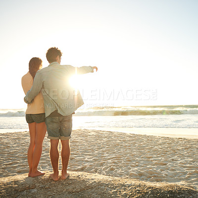 Buy stock photo Beach sunset, hand pointing or couple in nature with hug, support or love. Summer, romance or back of people at sunrise with ocean view, conversation or adventure on vacation, holiday or Florida trip
