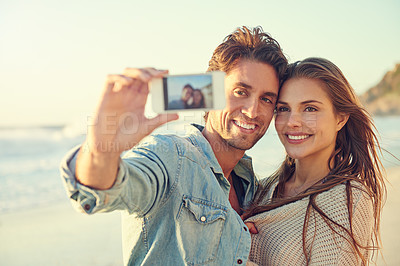 Buy stock photo Couple, selfie and happy for hug at beach for memory on vacation with care, love and bonding in summer. Man, woman and smartphone screen for photography, profile picture and post on social network