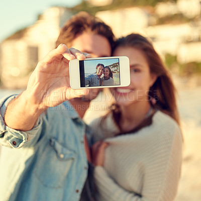 Buy stock photo Couple, selfie and smile for hug by ocean for memory on vacation with care, love and tropical beach. Man, woman and smartphone screen for photography, profile picture and app by sea on social media