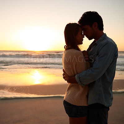 Buy stock photo Couple, hug and love on beach at sunset for bonding marriage or vacation, weekend or peace. Man, woman and embrace on sea sand for calm on tropical holiday for coast adventure, summer or mockup space