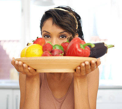 Buy stock photo Portrait, eyes and vegetables with a woman in the kitchen of her home for nutrition, diet or meal preparation. Health, ingredients and a recipe for cooking food with a young person in her apartment