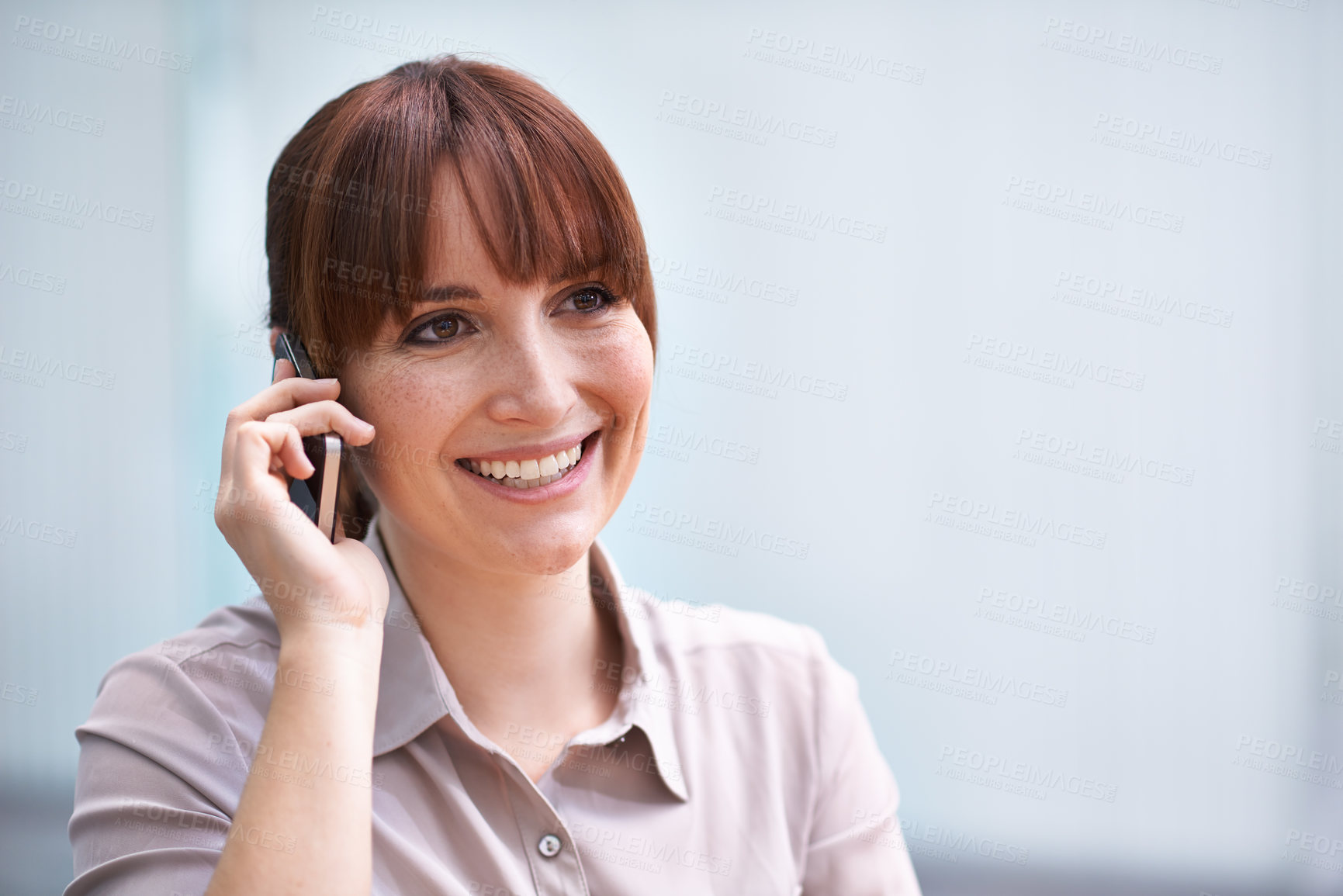 Buy stock photo Shot of a beautiful young businesswoman talking on a cellphone