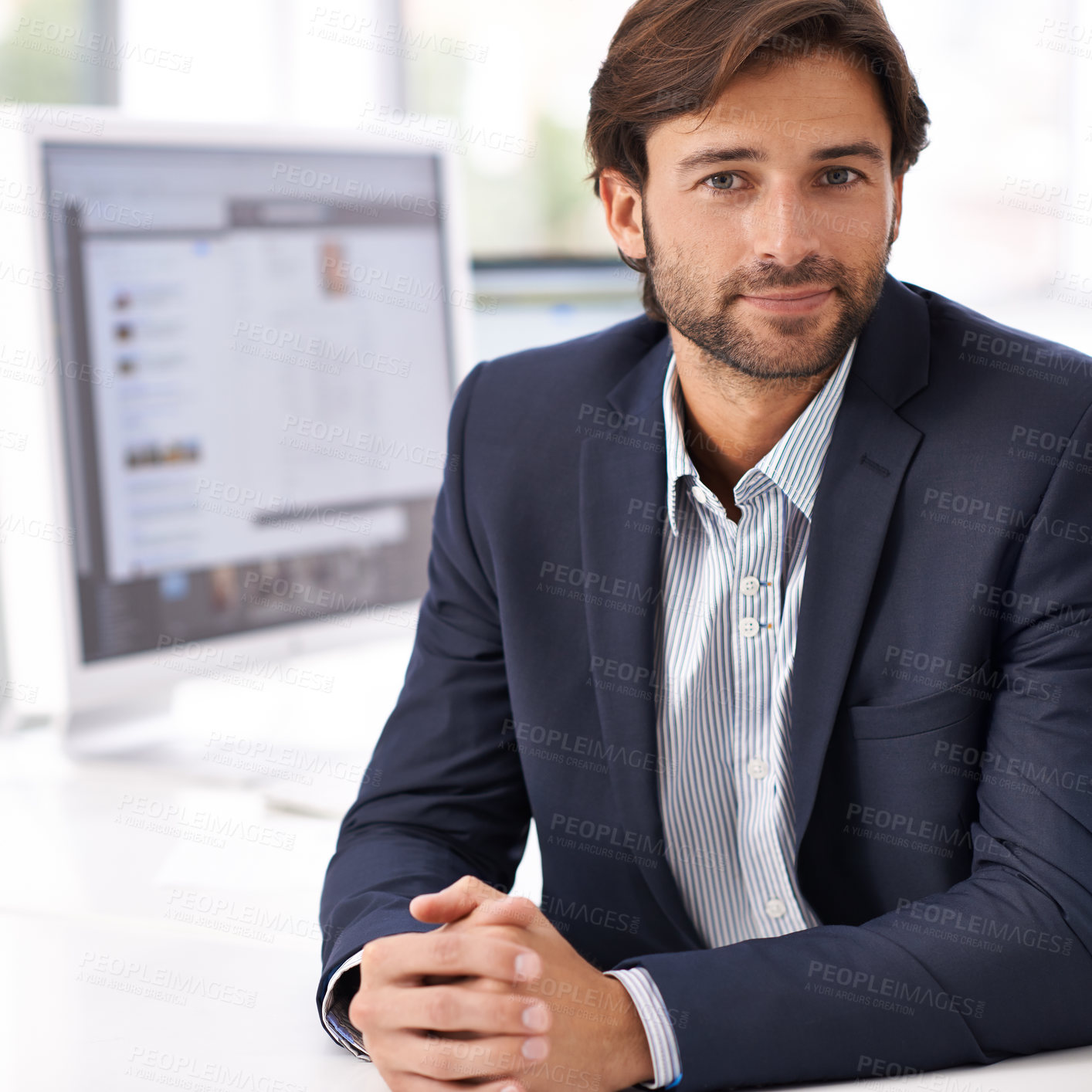 Buy stock photo Portrait of a handsome man sitting at a desk in an office