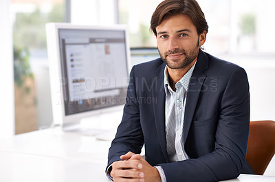 Buy stock photo Portrait of a handsome man sitting at a desk in an office