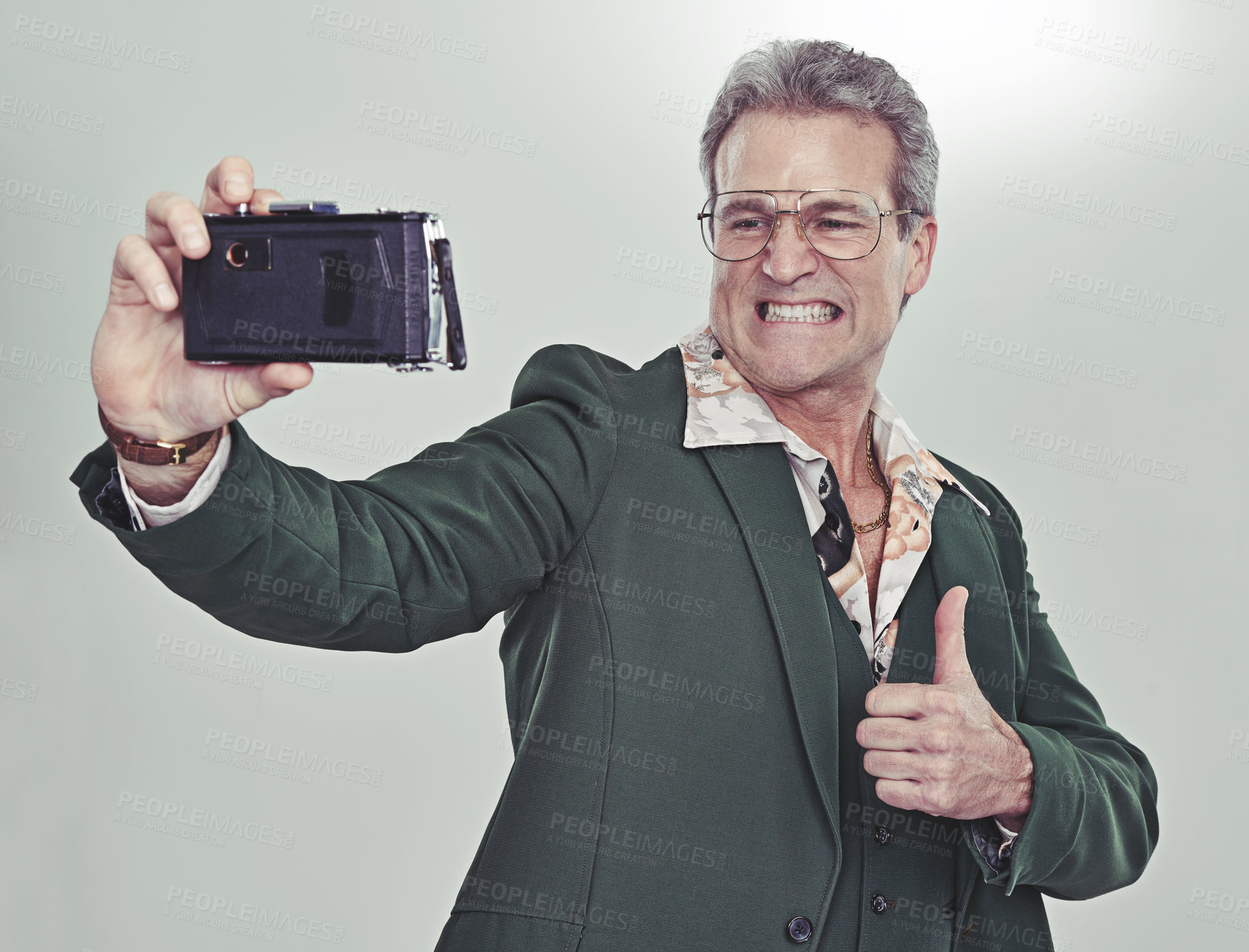 Buy stock photo Senior man, fashion and selfie with thumbs up for good job, winning or photography on a gray studio background. Mature person in retro or vintage style and like emoji or yes sign for photo or picture