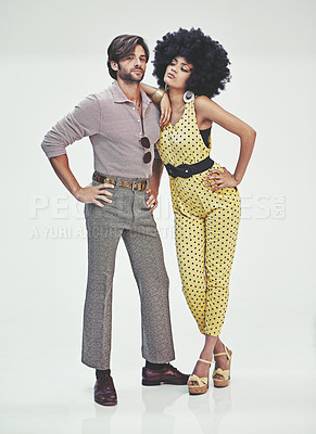 Buy stock photo An attractive young couple standing together in retro 70s clothing