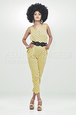 Buy stock photo Full length portrait of young woman wearing a 70s retro jumpsuit striking a pose in studio