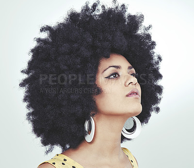 Buy stock photo Shot of a young woman with an afro wearing a retro outfit posing in studio