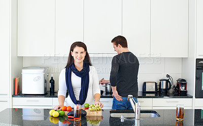 Buy stock photo Cropped shot of a couple cooking in the kitchen