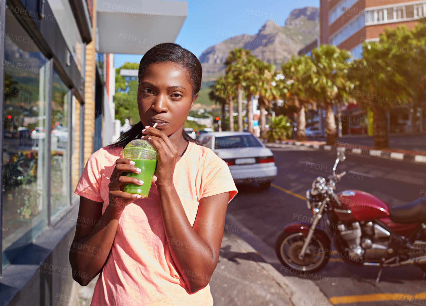 Buy stock photo Black woman, portrait and fitness with smoothie in city for hydration, detox or health and wellness. Young African, female person or drinking with green juice for nutrition, weight loss or vitamins