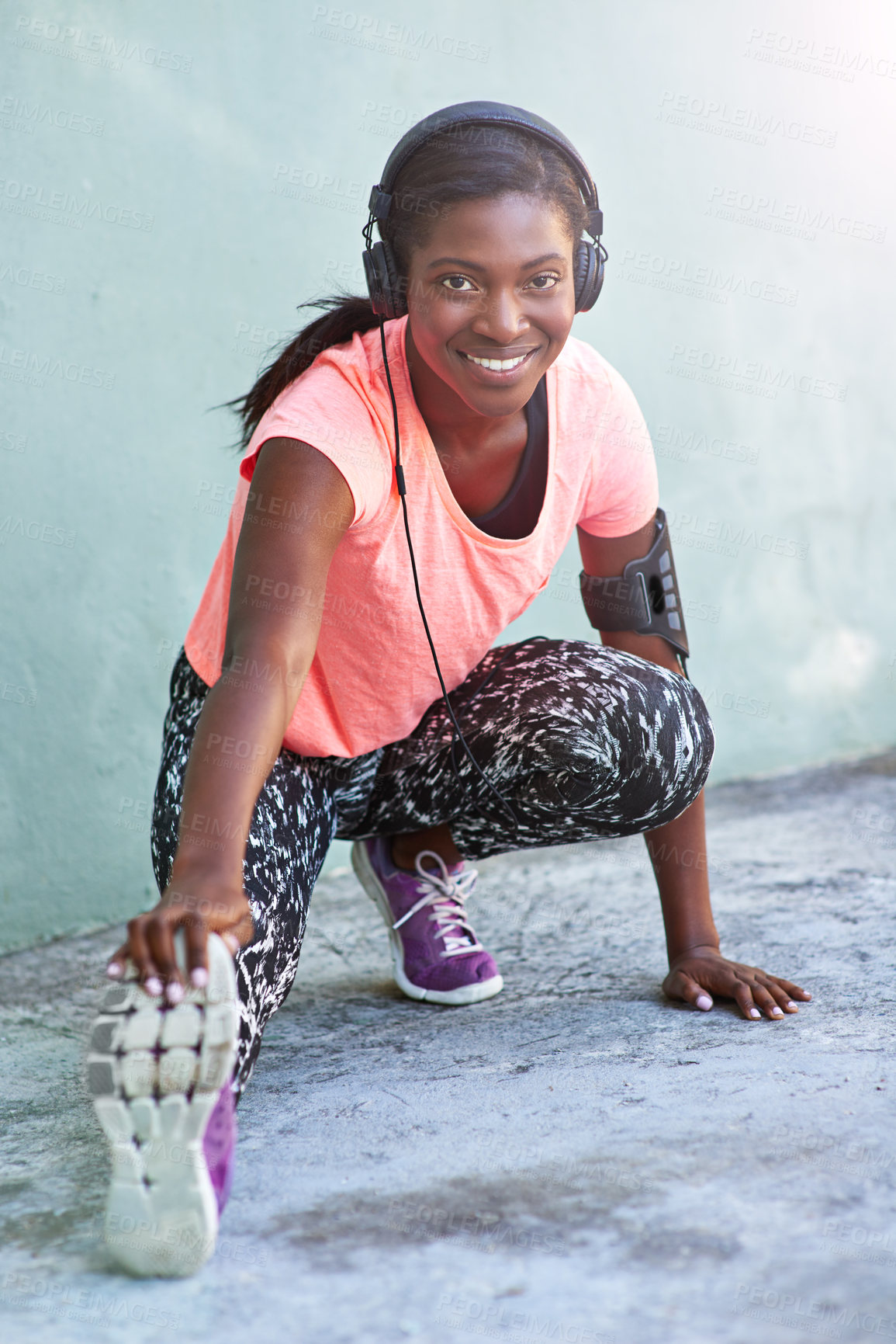 Buy stock photo Happy, portrait or black woman with headphones for stretching, fitness or workout preparation in city. Young African, female person or runner with smile for warm up exercise, music or audio streaming