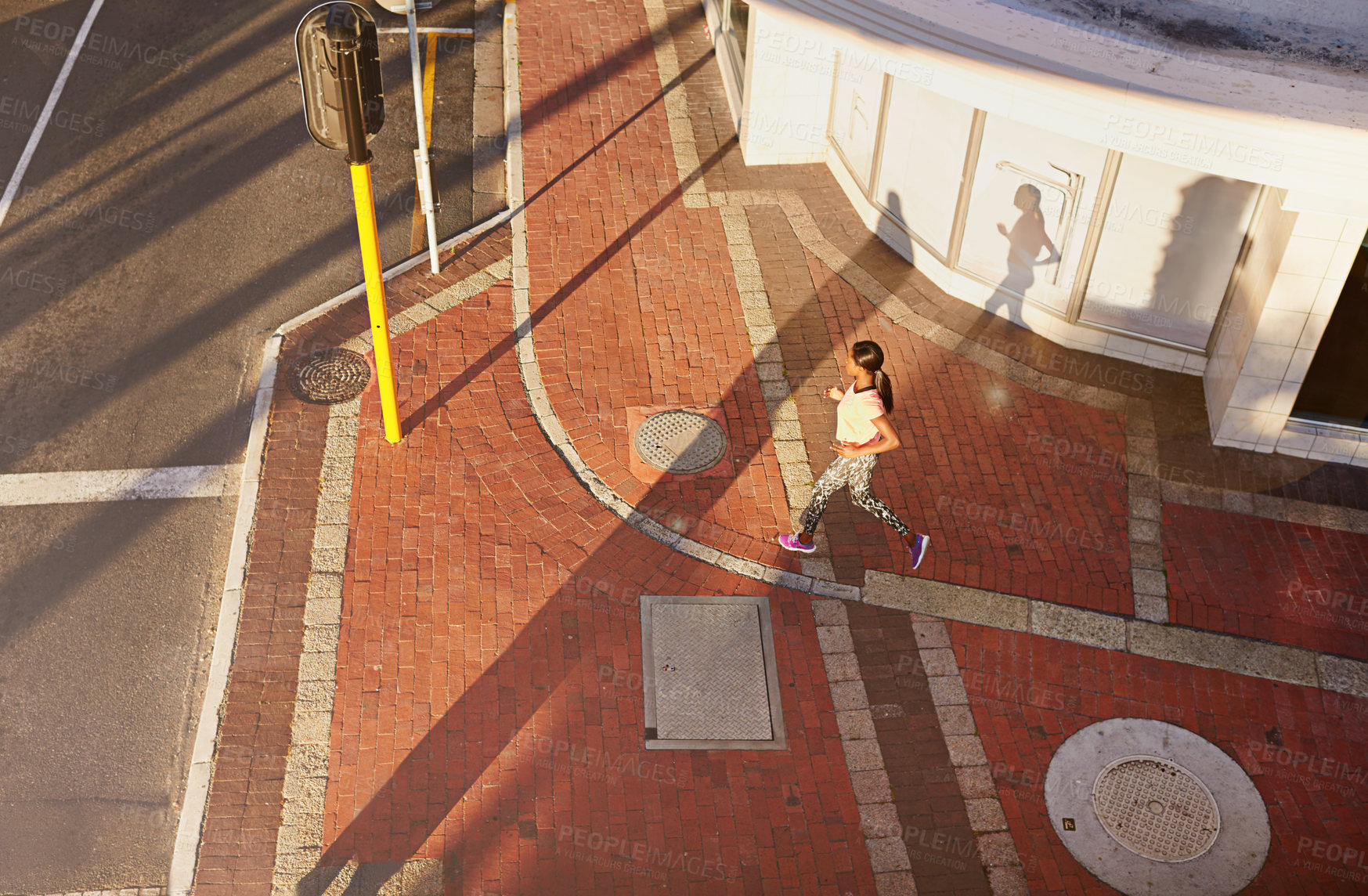 Buy stock photo Woman, running and above with city street for fitness, workout or outdoor training on sidewalk. Top view, female person or runner with traffic light, pavement or road for exercise in an urban town