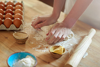 Buy stock photo Cropped shot of a set of hands kneading dough