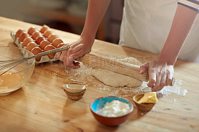 Buy stock photo Cropped shot of a set of hands rolling out dough