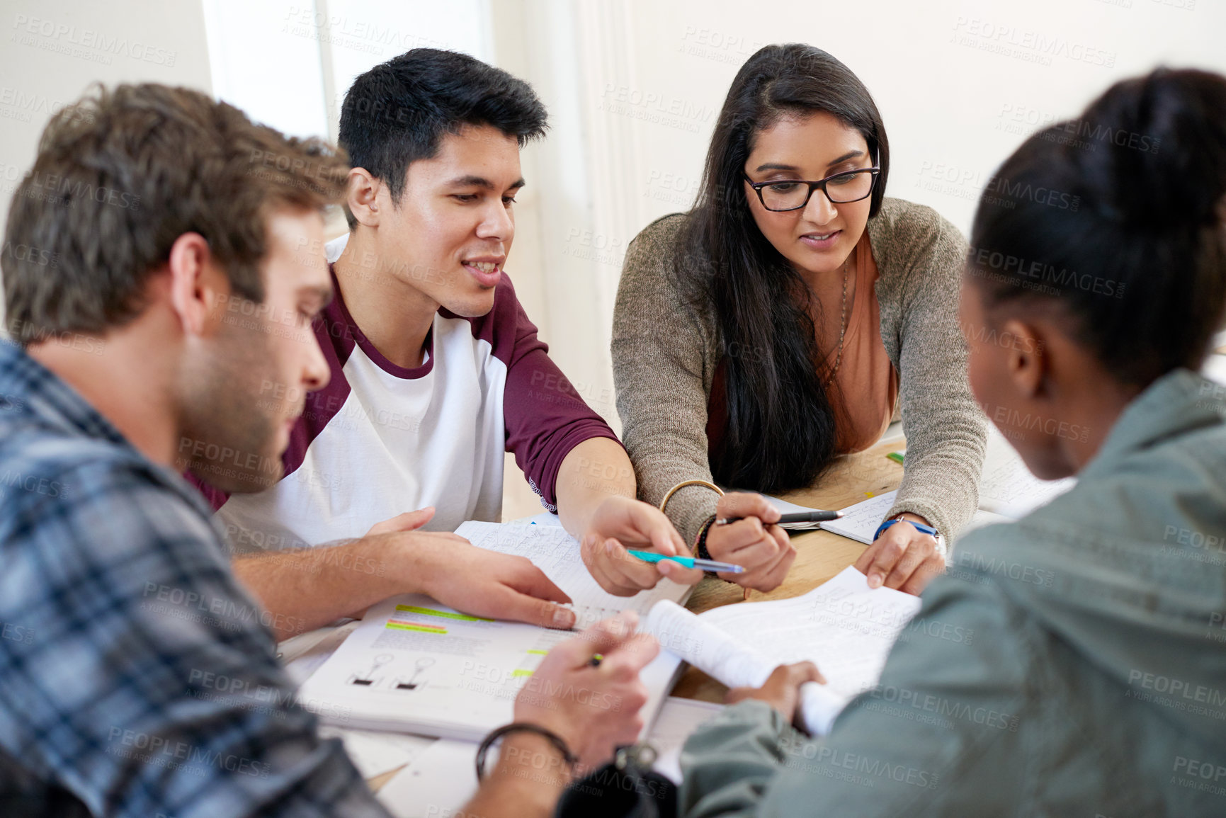 Buy stock photo Team, students and studying in university library for learning, knowledge or brainstorming test. College, friends and people reading book for information, education or help for exam in class together