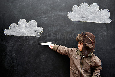Buy stock photo Children, chalkboard and paper plane with boy in studio on black background for fantasy game. Education, class and kid pilot in costume at playing school for growth, learning or child development