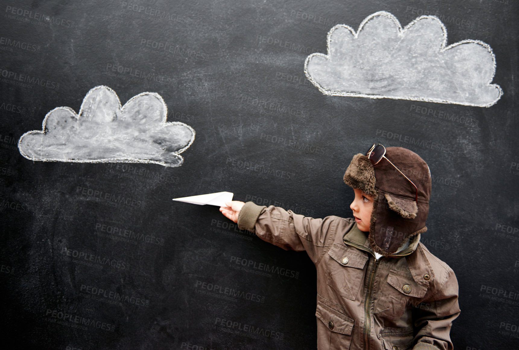 Buy stock photo Children, chalkboard and paper plane with boy in studio on black background for fantasy game. Education, class and kid pilot in costume at playing school for growth, learning or child development