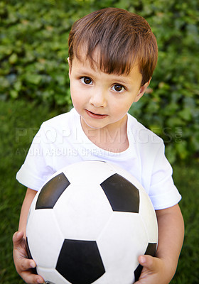 Buy stock photo Portrait, young boy and hold with football in garden for fun game, exercise and fresh air in Peru. Closeup, innocent and male kid with soccer ball for outdoor activity and childhood development