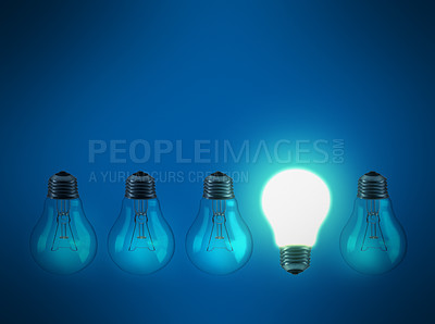 Buy stock photo Studio shot of a row of lightbulbs against a blue background