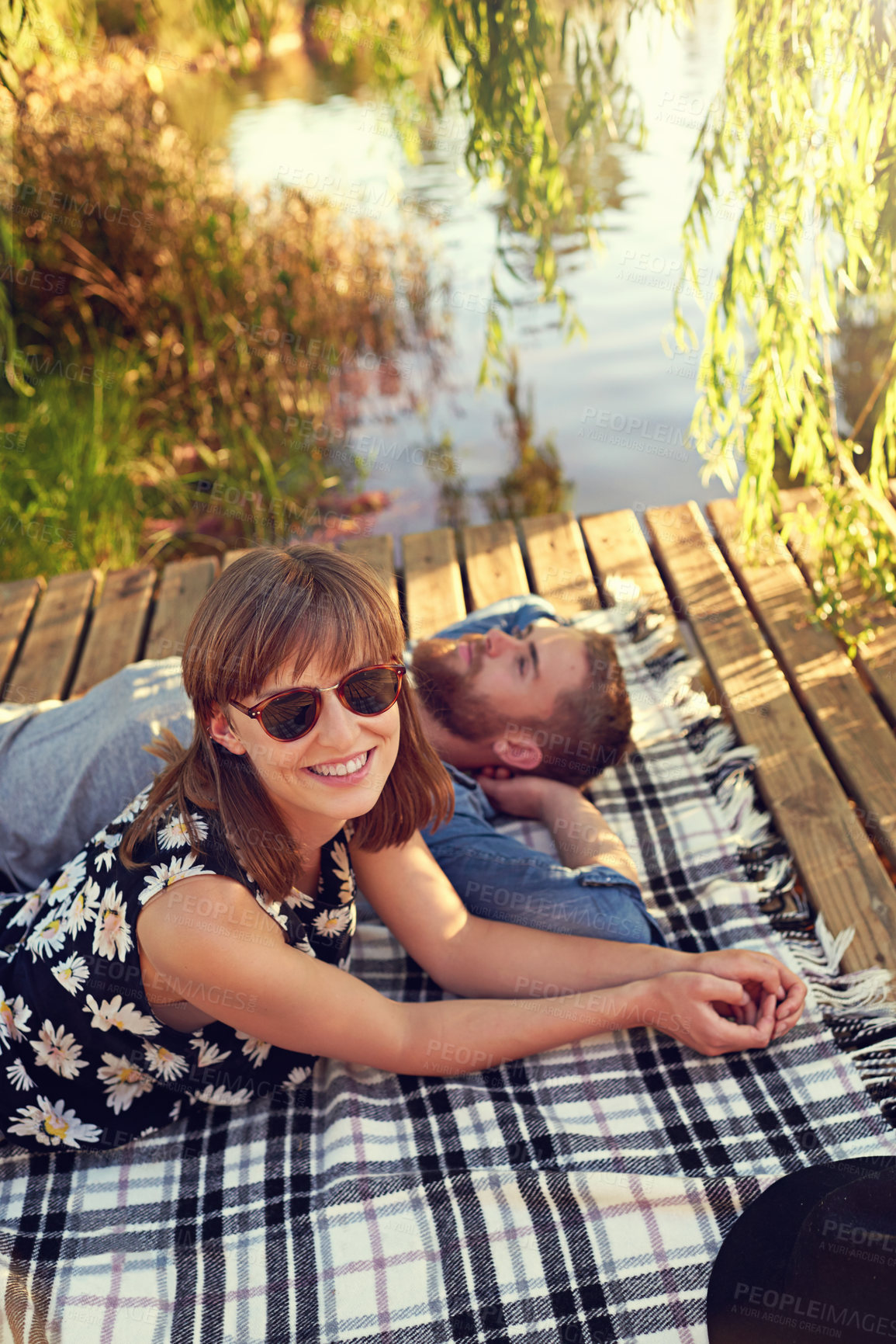 Buy stock photo Outdoor, couple and happy for picnic on lake with love, rest and affection for care. Lake, people and relationship with smile on blanket on valentines day for holiday to relax, chill and bonding