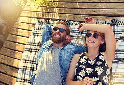 Buy stock photo Lakeside, couple and smile with lying on ground on break with love, rest and affection for care. Above, outdoor and happy in relationship on blanket on valentines day for holiday to relax and bonding