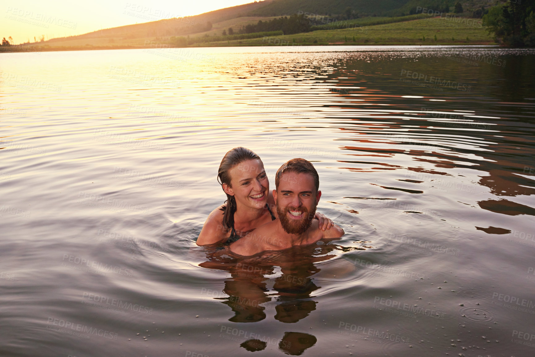 Buy stock photo Portrait, sunset or happy couple swimming at lake together on vacation, romantic anniversary or holiday. Relationship, smile or people in water for bonding, love or trust on honeymoon date for travel