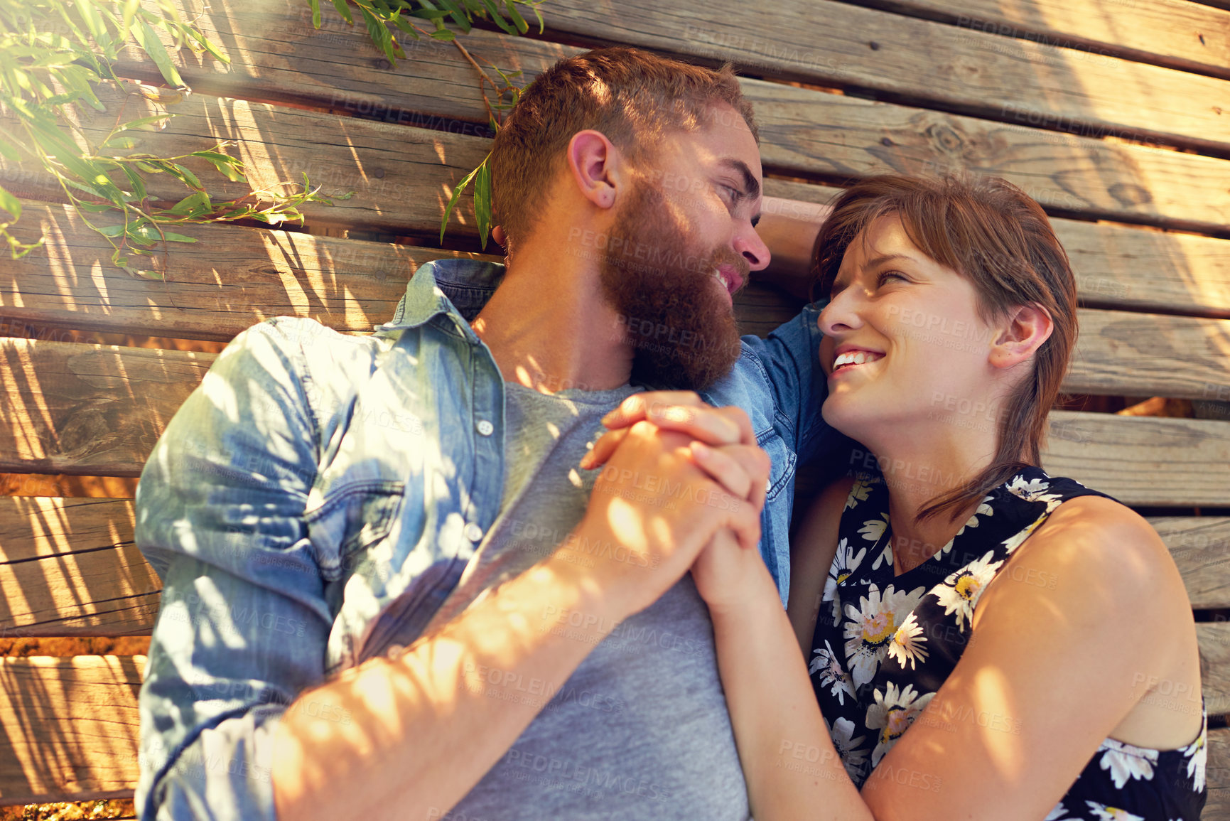 Buy stock photo Holding hands, couple and lying on ground for picnic on break with love, rest or affection for care. Wood, outdoor and relationship with smile on valentines day for holiday to relax, chill or bonding