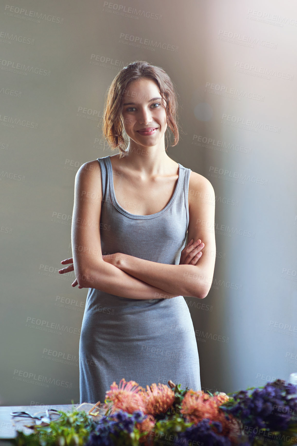 Buy stock photo A young woman in the process of making a flower arrangement