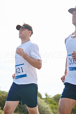 Buy stock photo Shot of young men running a marathon