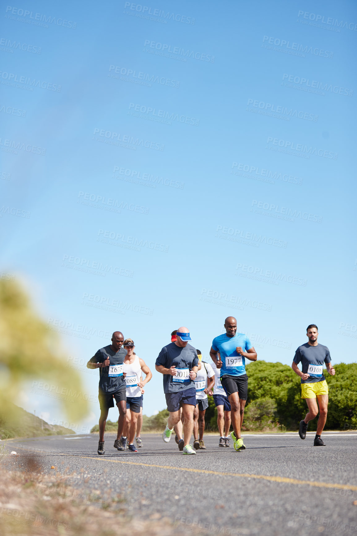 Buy stock photo People, running tournament and outdoor marathon for fitness, cardio challenge and road for endurance. Athletes, mockup space and blue sky for workout in nature, international competition and sports