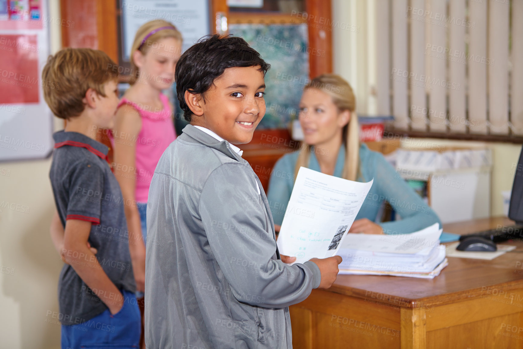 Buy stock photo Teacher, portrait or happy kid with paper in classroom for education, learning or tutoring at school. Boy, smile or educator helping a group of young students or children with paperwork for studying