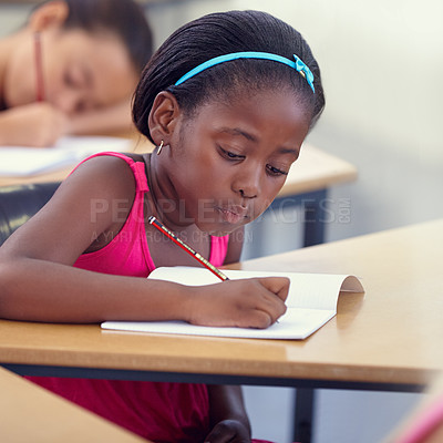 Buy stock photo Black girl, school or writing in classroom with notebook, studying lesson or learning academic assessment at desk. Student, child or kid drawing on paper in educational development, test or knowledge