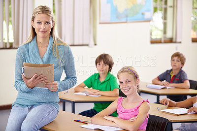 Buy stock photo Portrait, teacher and woman with children in classroom, smile and holding folder. Happiness, female educator and students ready for learning, knowledge or studying in elementary school for education.