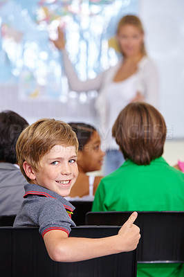 Buy stock photo Child, portrait and thumbs up of student in classroom, elementary school or class. Smile, education and kid with hand gesture for like emoji, agreement or learning, success and approval sign.