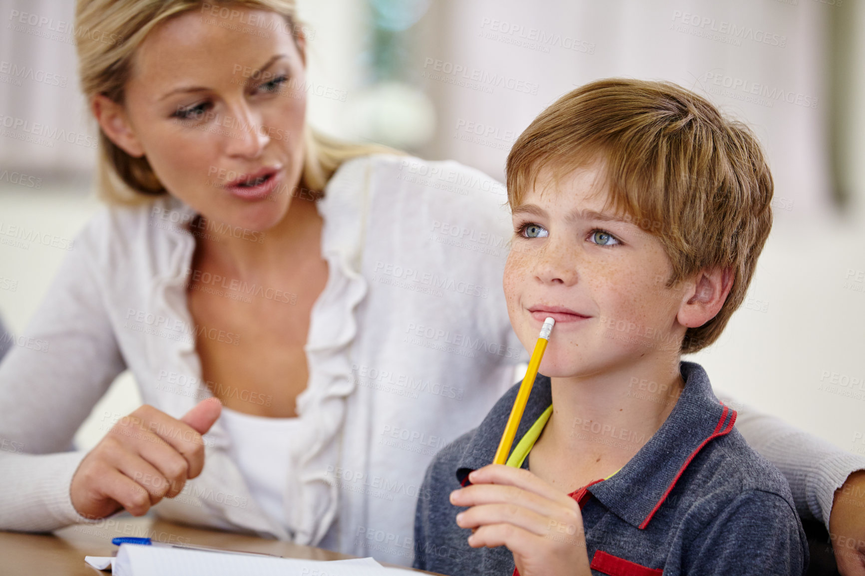 Buy stock photo School, woman helping student with homework or question and in classroom. Education or learning, female teacher assisting male child and boy with pencil at mouth for thinking or find solution.