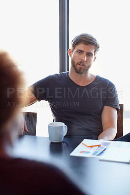 Buy stock photo Shot of two colleagues having a discussion in the office